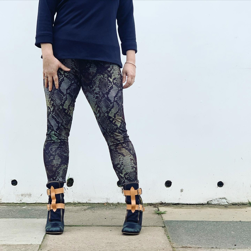 Front view of Janene wearing her handmade snakeskin leggings. Her feet are slightly apart. There are some small wrinkles on the knees.