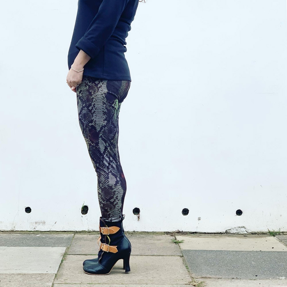 Side view of Janene wearing her handmade snakeskin print leggings and high heel boots. Her head is cropped out of the image.