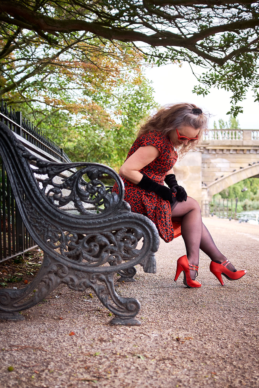 Adjusting stockings on a bench by the Serpentine, London