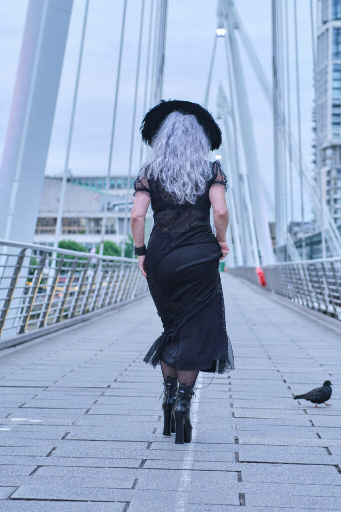 back view of model as she walks over a bridge
