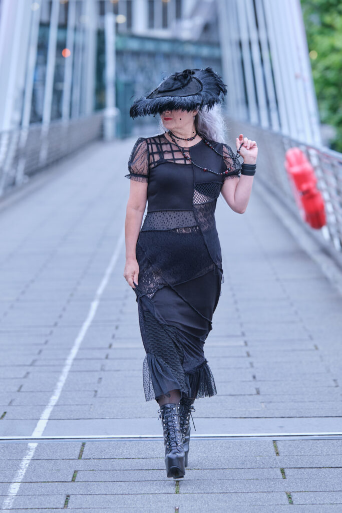 front view of model as she walks over a bridge